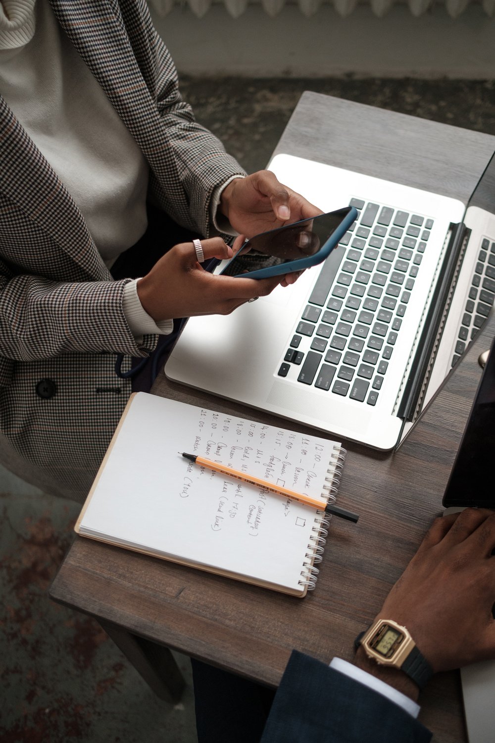 Businesswoman Using Smartphone and Laptop in Office